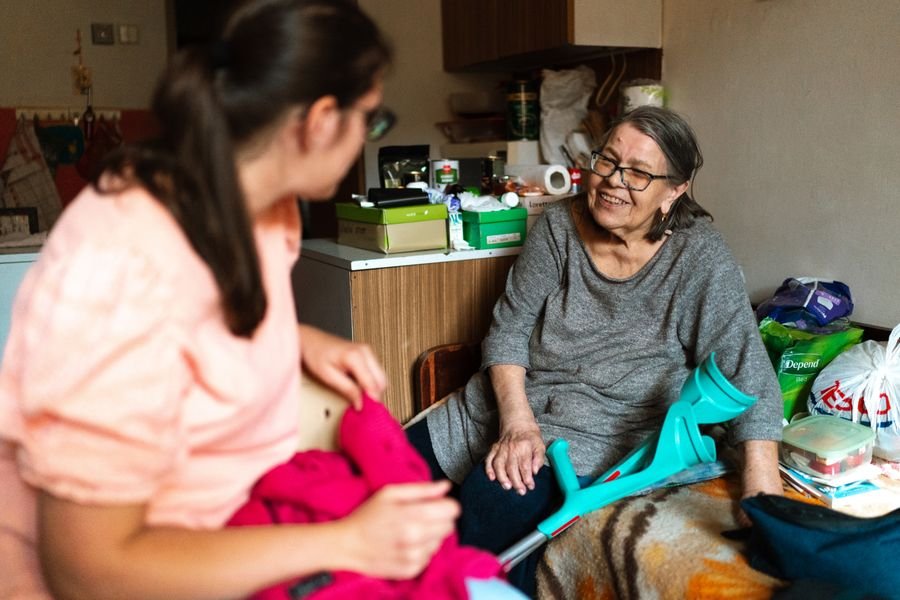 Caregiver assisting a senior with mobility at home