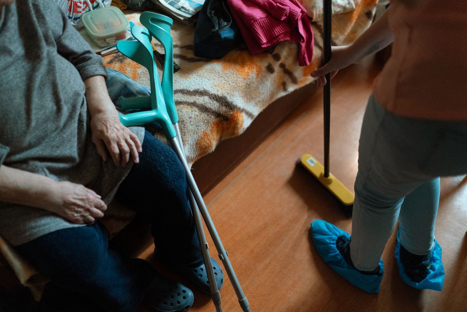 Caregiver helping a senior with household cleaning at home